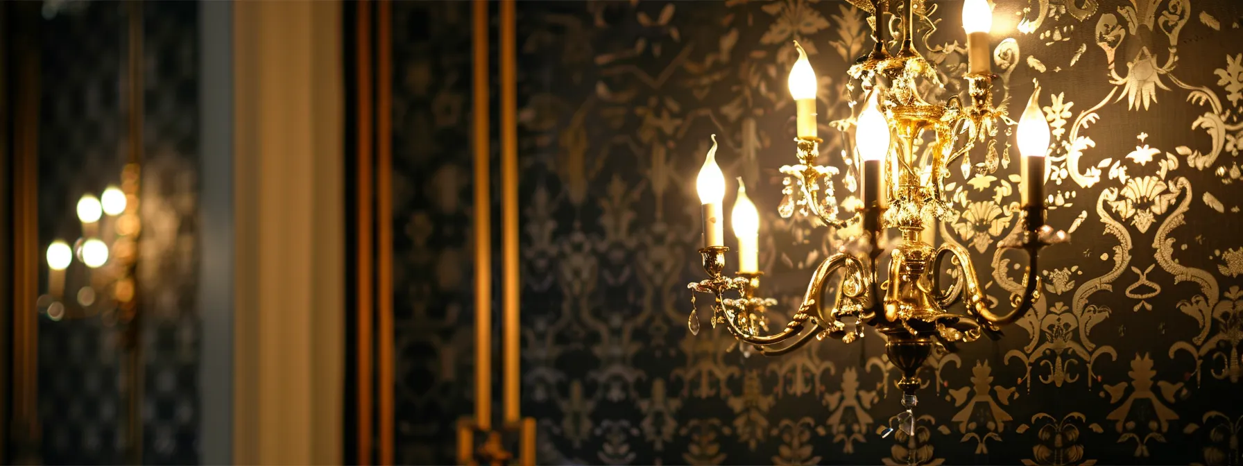 an elegant chandelier illuminating a beautifully patterned wall in a well-designed room.