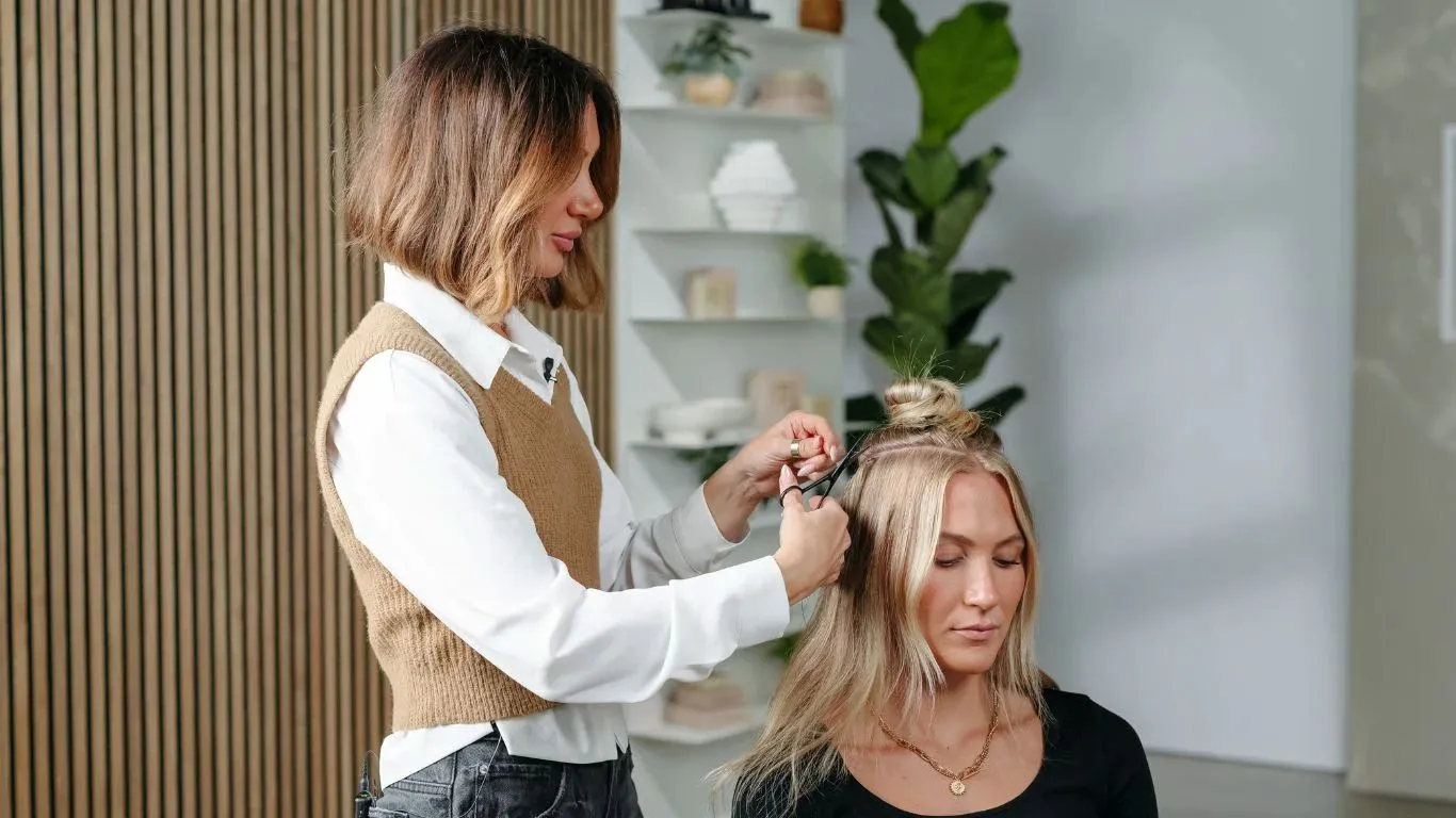 stylist installing hair extensions on the client stylist installing hair extensions on the client