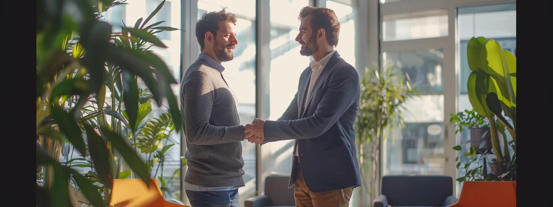 a businessman shaking hands with a digital marketing partner in a modern office setting.