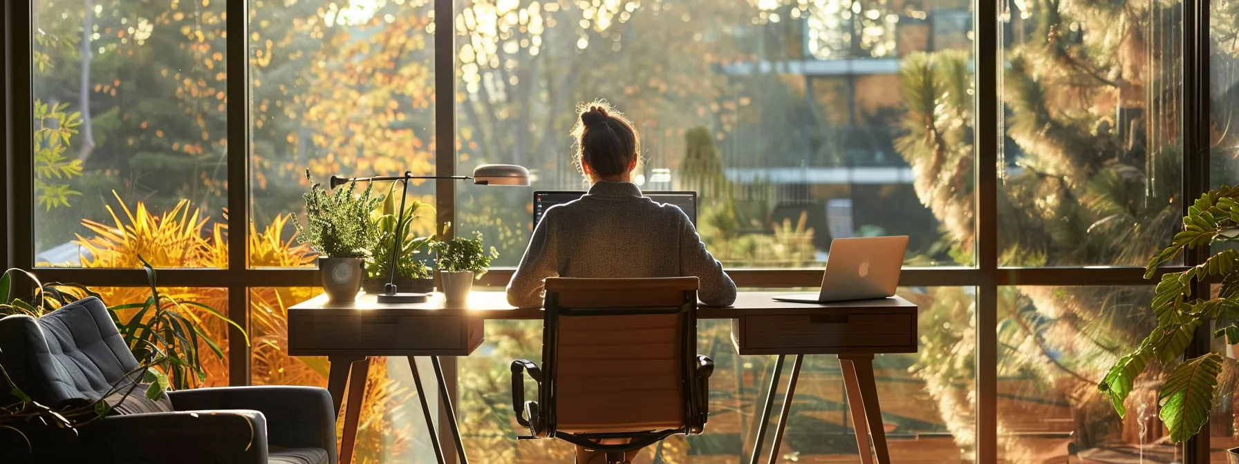 a person sitting at a desk with a laptop on one side and a serene outdoor view on the other.