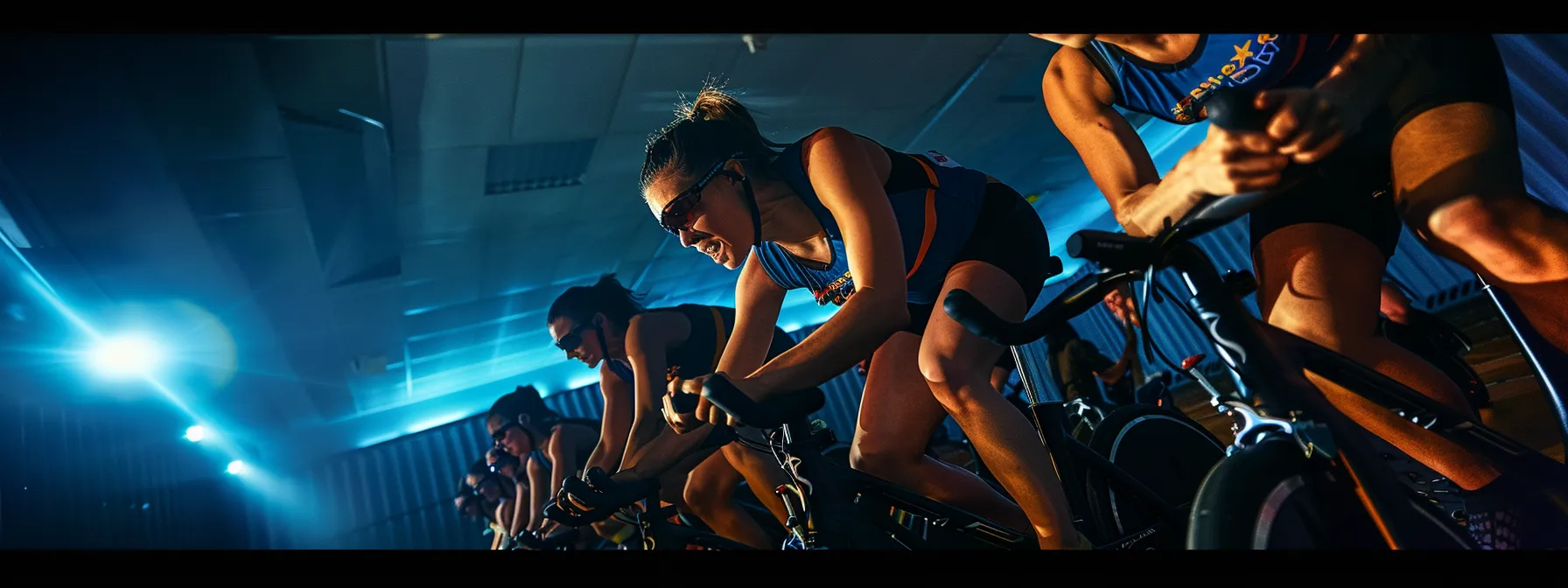 riders in a spin class pedal in sync to the beat of the music, pushing their limits together.