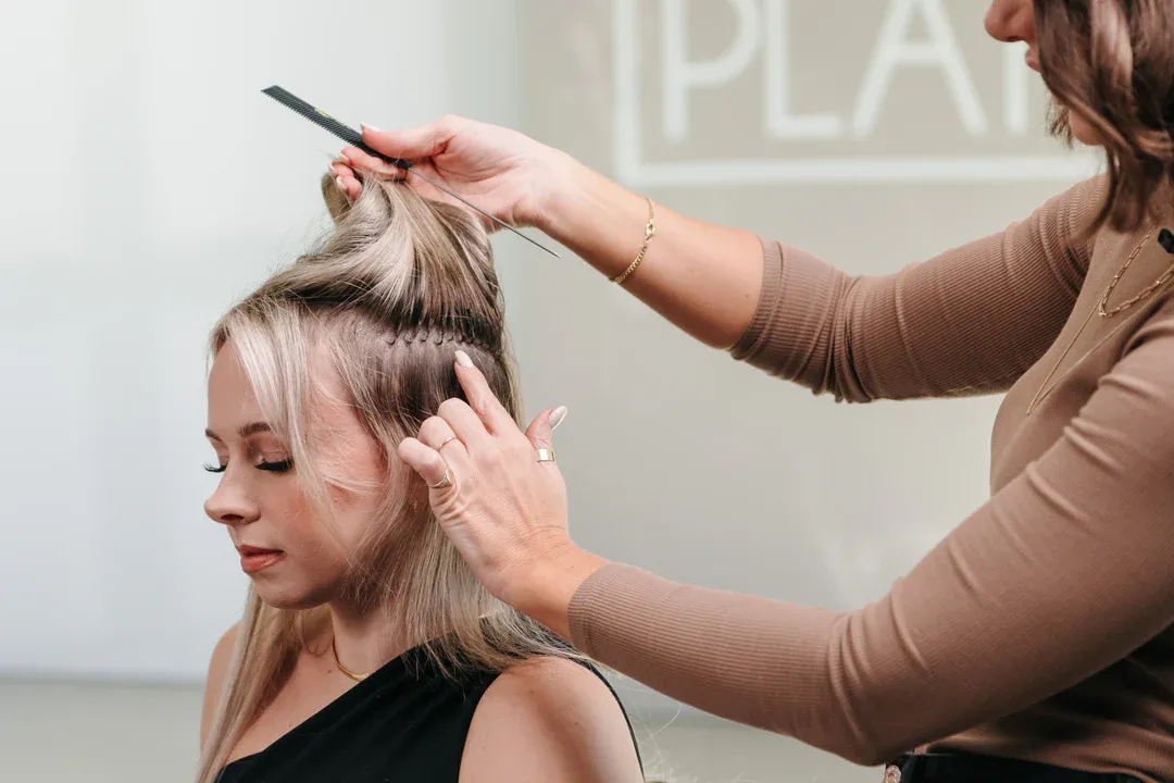 stylist showing k-tips hair extensions application stylist showing k-tips hair extensions application