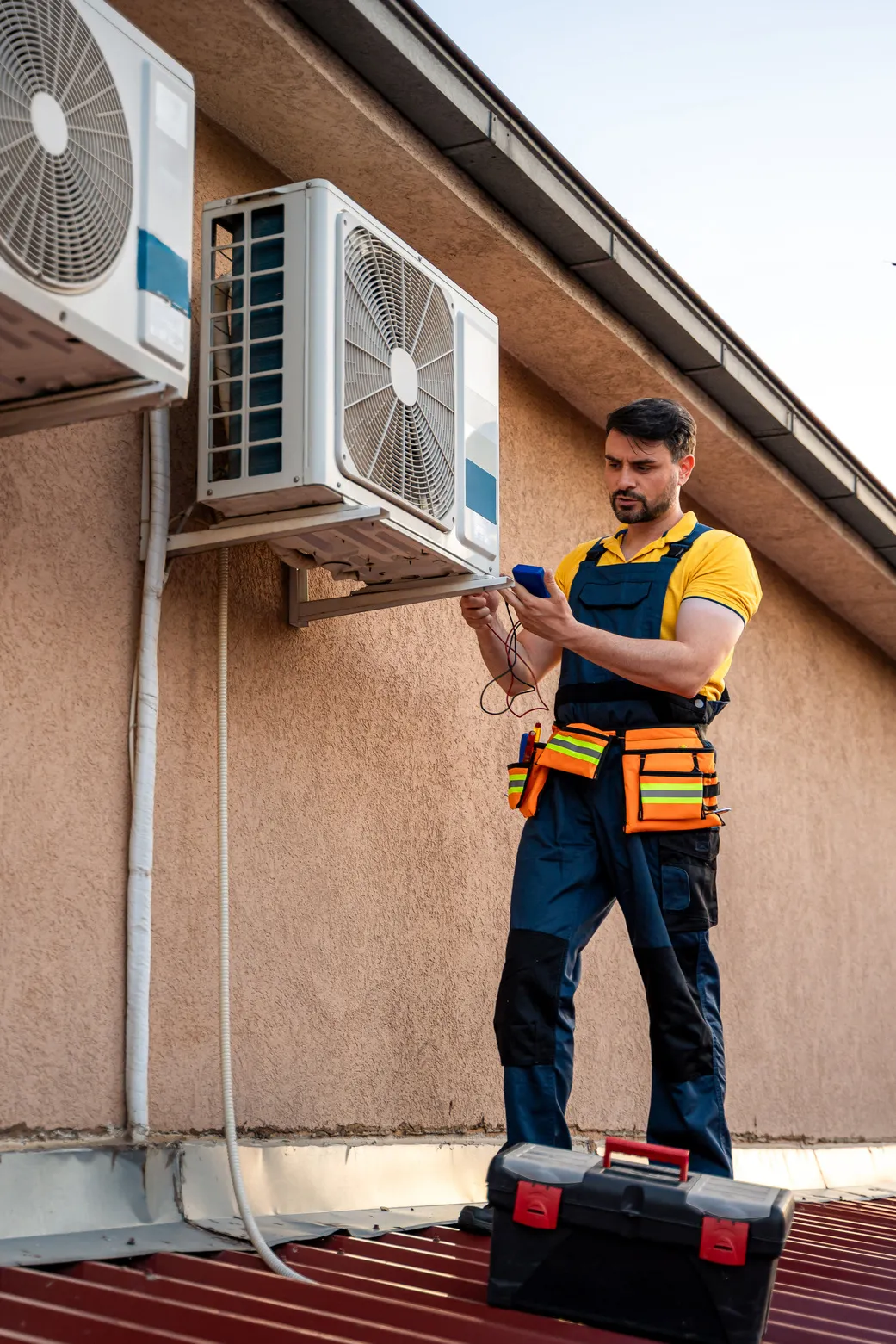 Technician inspecting an outdoor AC unit to ensure reliable performance through preventive maintenance.