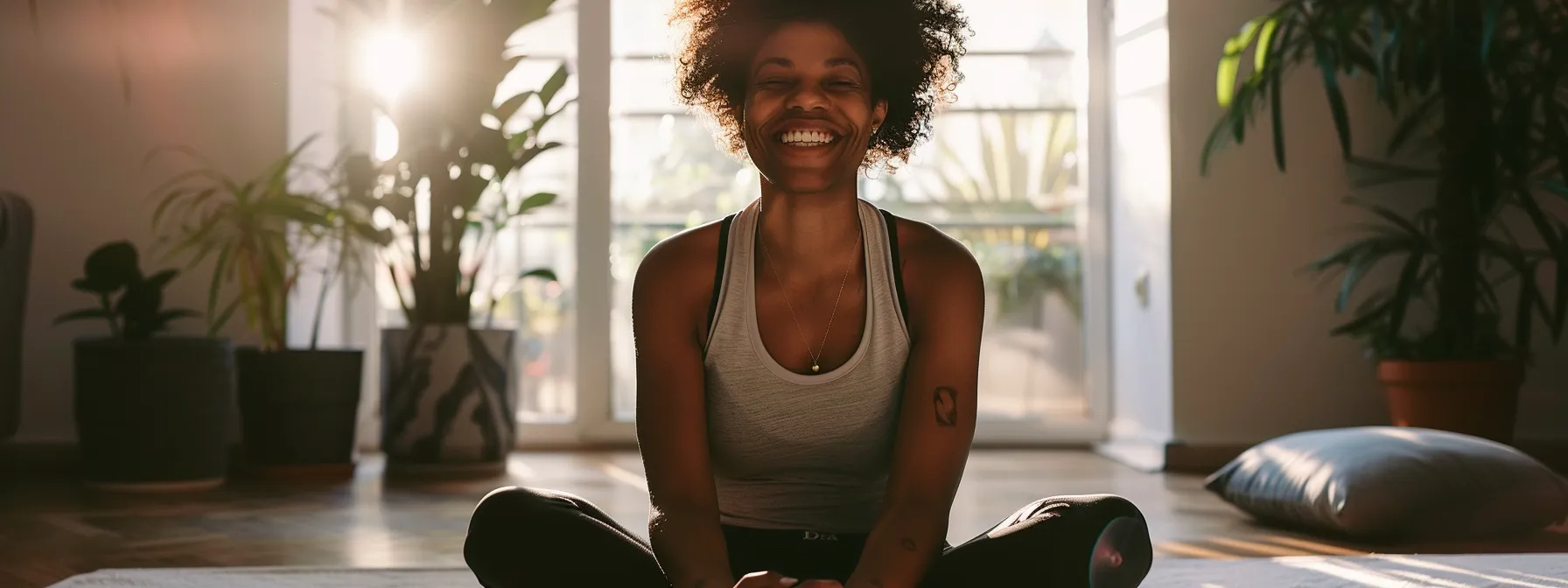 a person smiling brightly while working out at home with a virtual wellness coach on a video call.