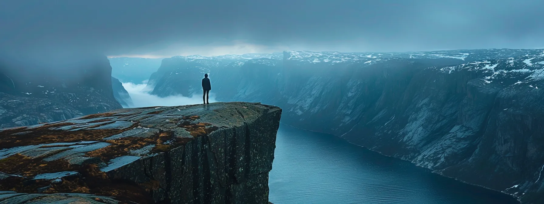 a person standing at the edge of a cliff, looking out into the vast unknown with determination in their eyes.