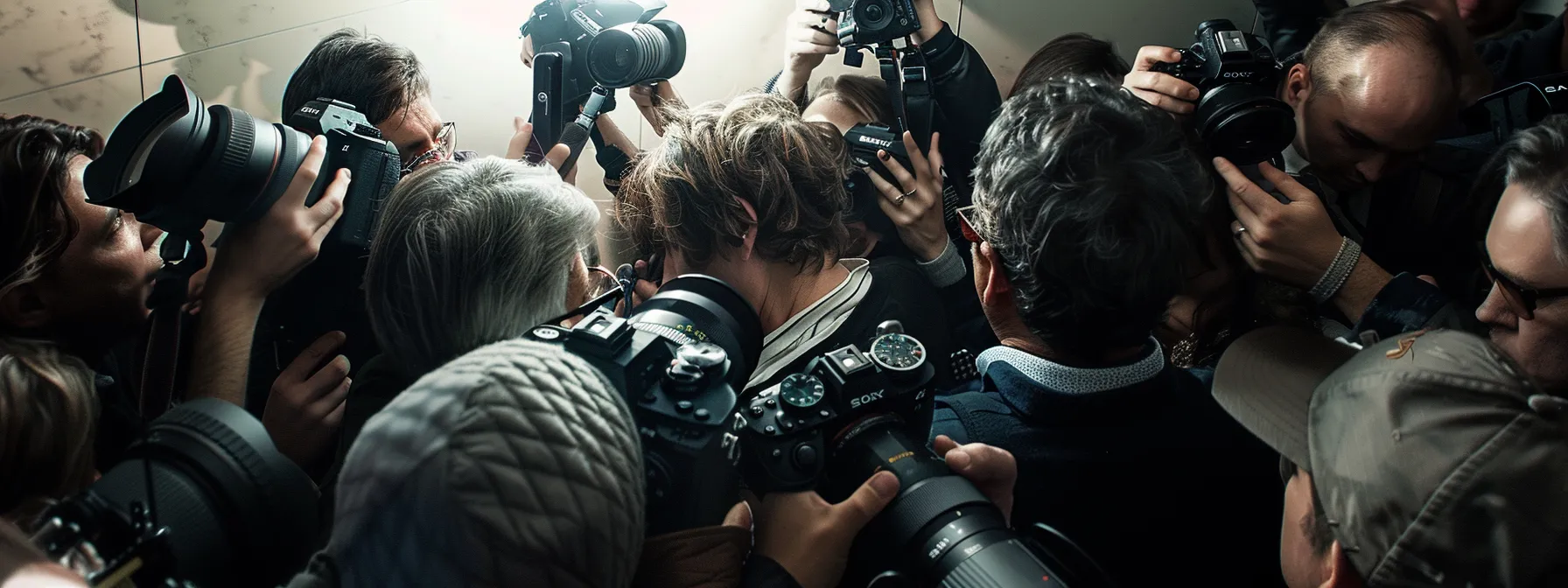 the paparazzi surround a distressed celebrity trying to shield themselves from the invasive cameras.