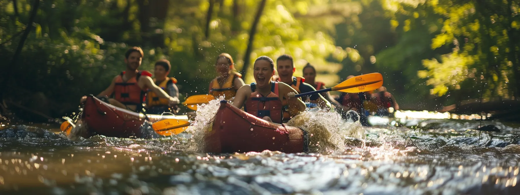 a group of friends cheer and laugh as they paddle down a rushing river together in tennessee.