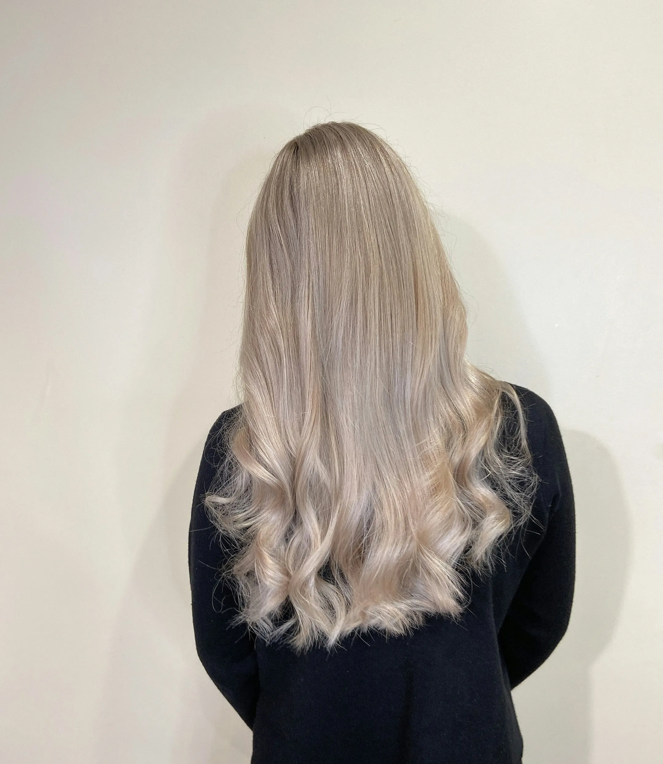Back view of healthy, shiny curls achieved with hand sewn wefts Back view of healthy, shiny curls achieved with hand sewn wefts