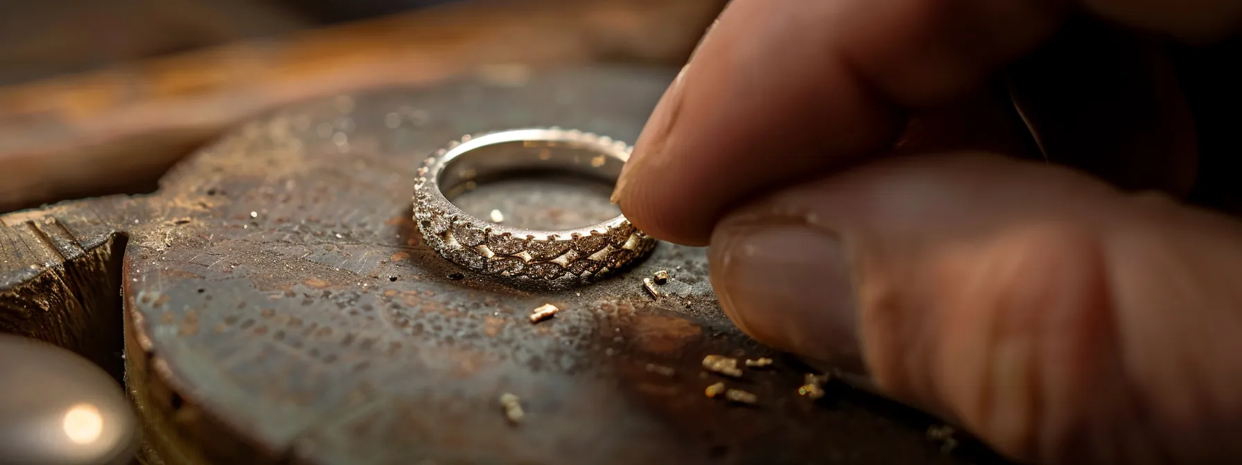 a jeweler carefully resizing a classic wedding band to preserve its integrity and beauty.