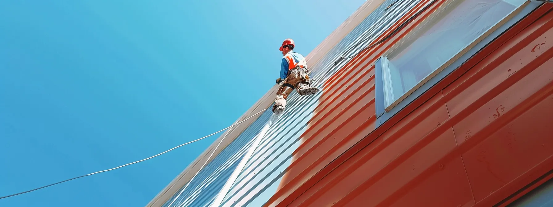inspecting vinyl siding for hidden damage after pressure washing, rinsing off detergent to prevent streaks, with a clear blue sky in the background. inspecting vinyl siding for hidden damage after pressure washing, rinsing off detergent to prevent streaks, with a clear blue sky in the background.