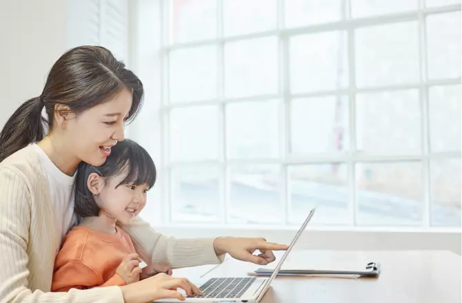 엄마와 함께 노트북을 보고 있는 아이