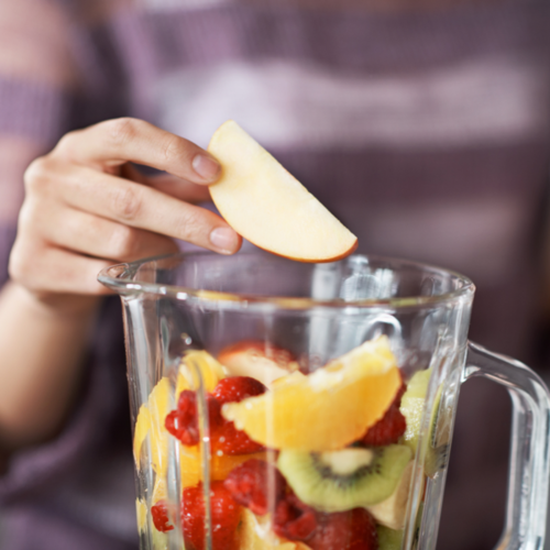 Woman Blending Fruit