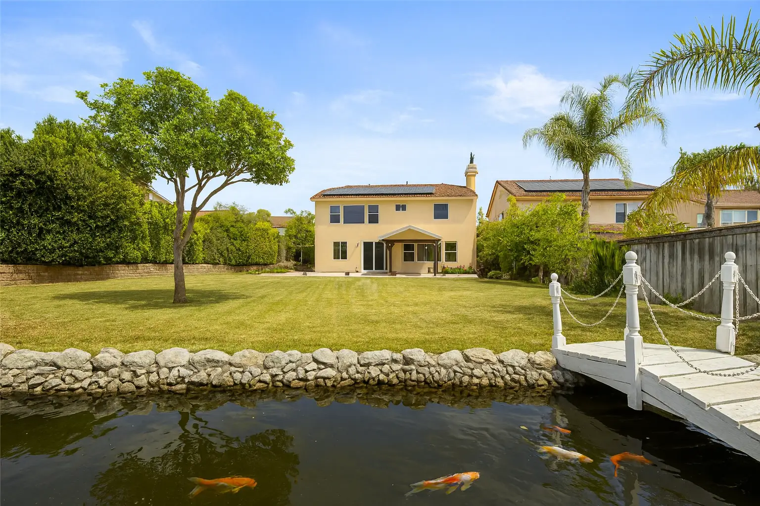 Santa Clarita backyard with a serene pond stocked with fish