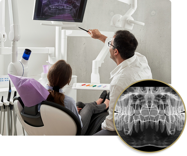 Dentist at Issa Dental Group reviewing a panoramic X-ray with a patient during a consultation.