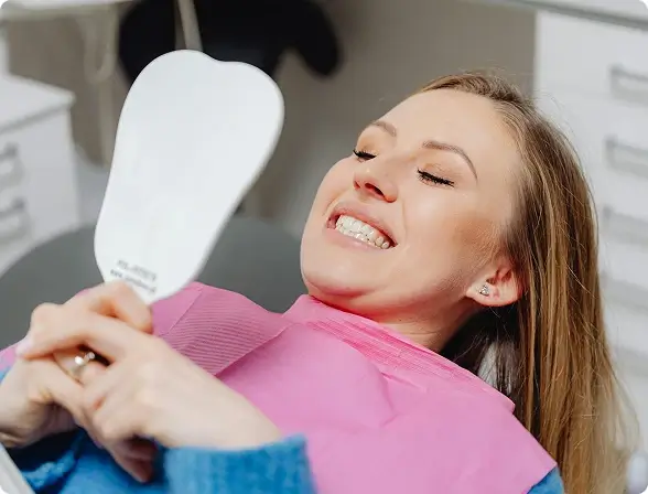 A dentist at Issa Dental Group performing a comprehensive preventive exam, smoothly integrating a life-saving oral cancer screening into the routine check-up.