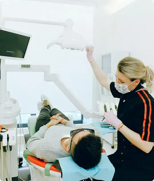 A dentist at Issa Dental Group reviewing digital X-rays and medical history with a patient to establish a personalized, long-term dental care plan.