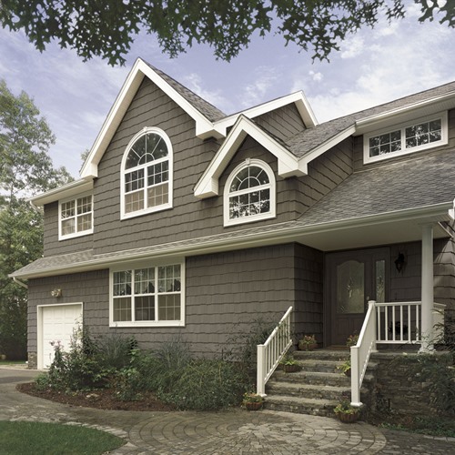 Upscale house with dark gray siding and white trim