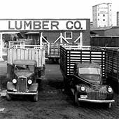 Vintage lumber company delivery trucks