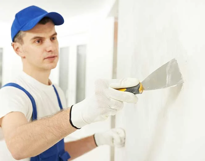 Patching a wall with a putty knife