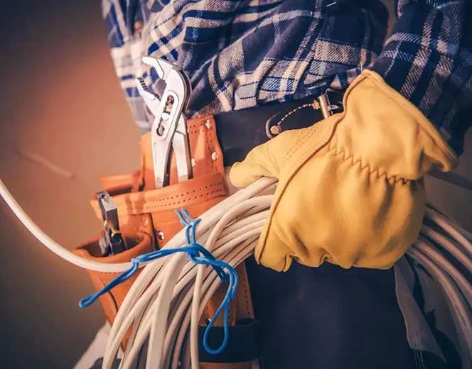 Electrician with wire and tool belt