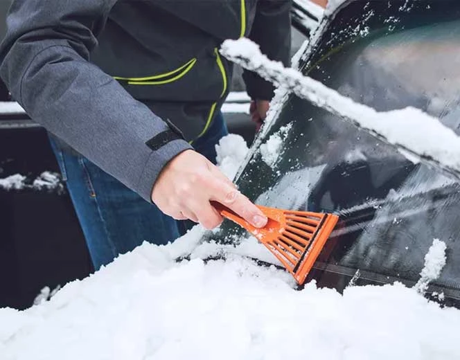Scraping snow off a car
