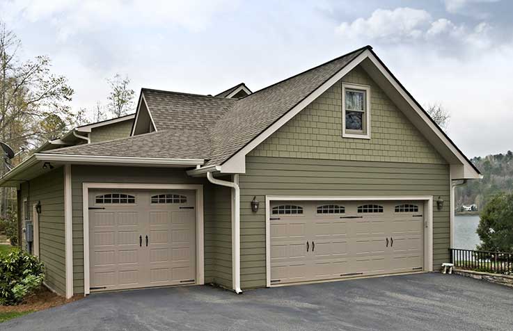 Green house with a three-car garage