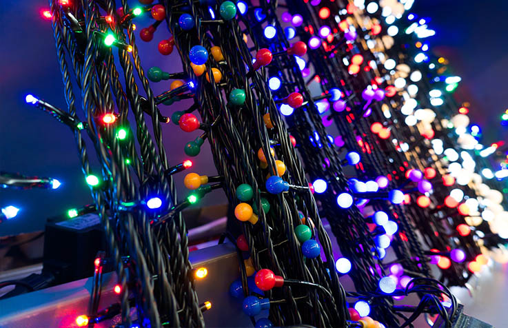Strings of colored holiday lights at night