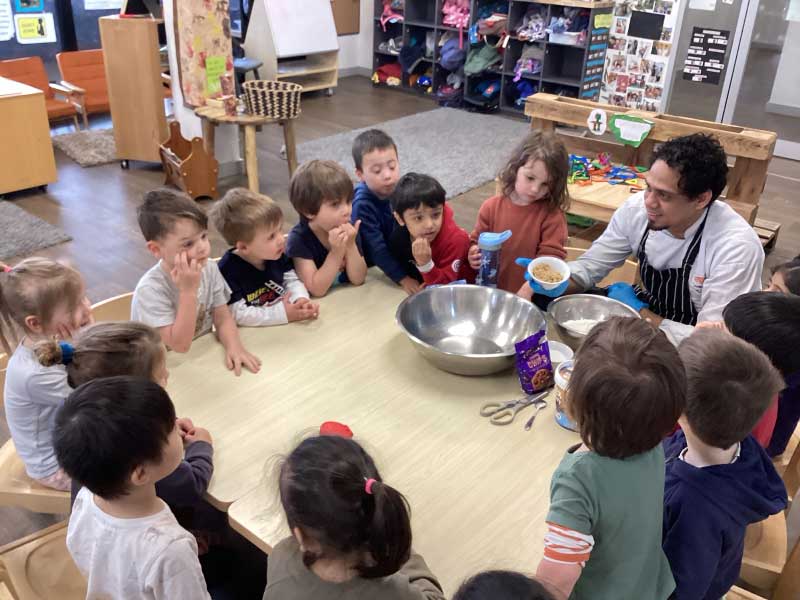 Chef Terrence engages a group of children in a cooking class at Kew of no bake energy bars.