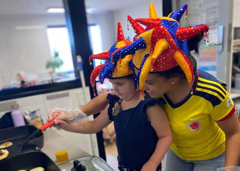 A child participates in a cooking experience with a parent at Petit ELJ where parents and educators collaborate on protecting children's rights in Australia.