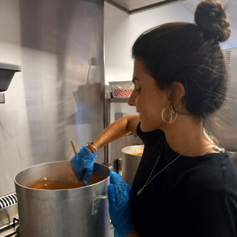 Chef Isabela stirs a pot for a scrumptious healthy meal for the children at Burleigh.