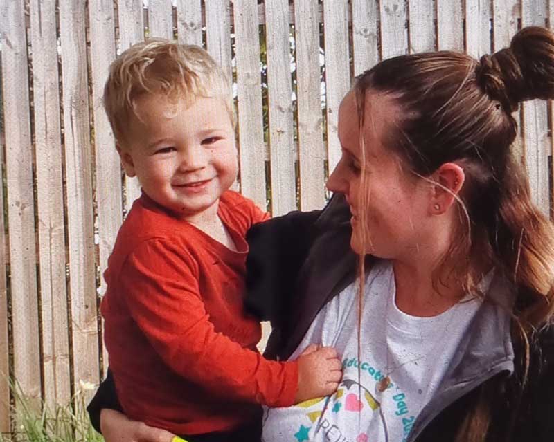  Jasmin holds a child for photo op on Educators Day which celebrates those educators who choose an early childhood career.