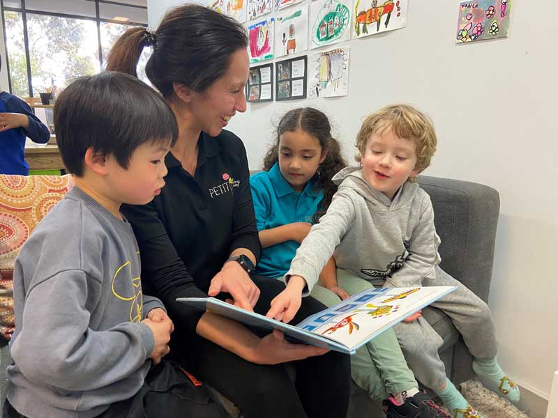 Lisa, a career changer and an early childhood Educator reads to young children.