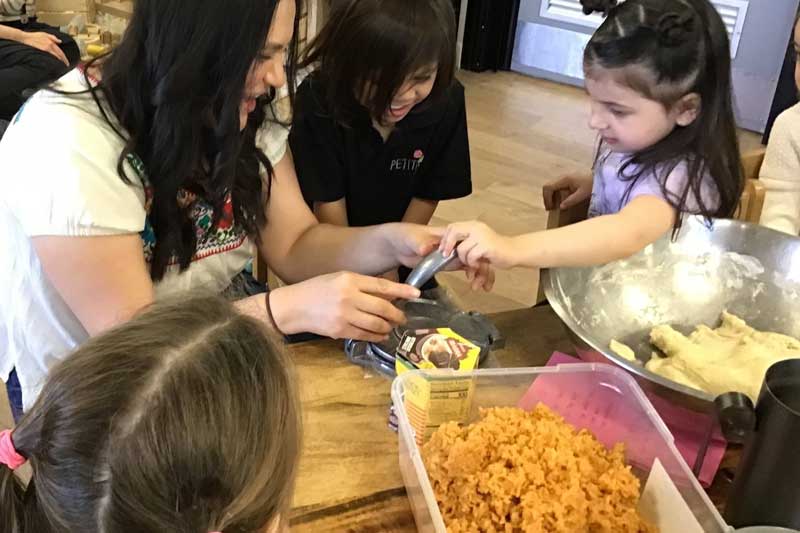 A group of kindergarten children prepare a traditional meal from the Mexican culture.