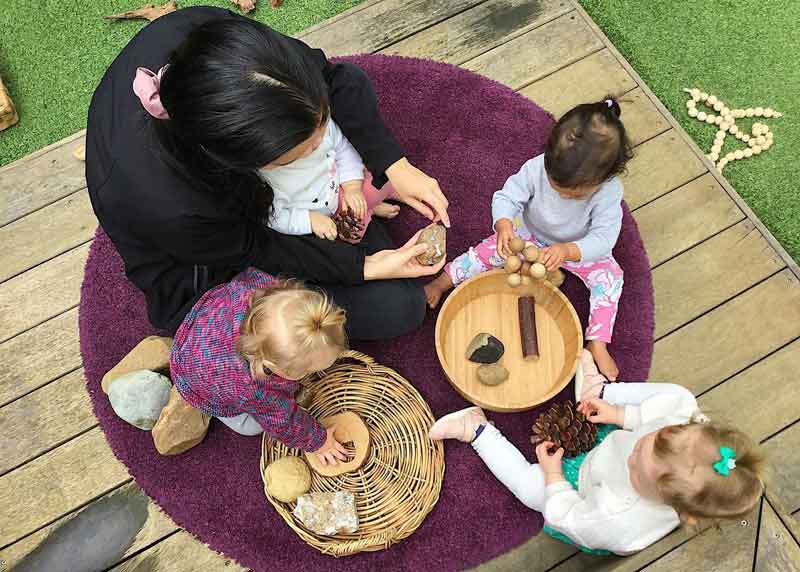 Children enjoy a sensory experience with natural resources - nature play for babies