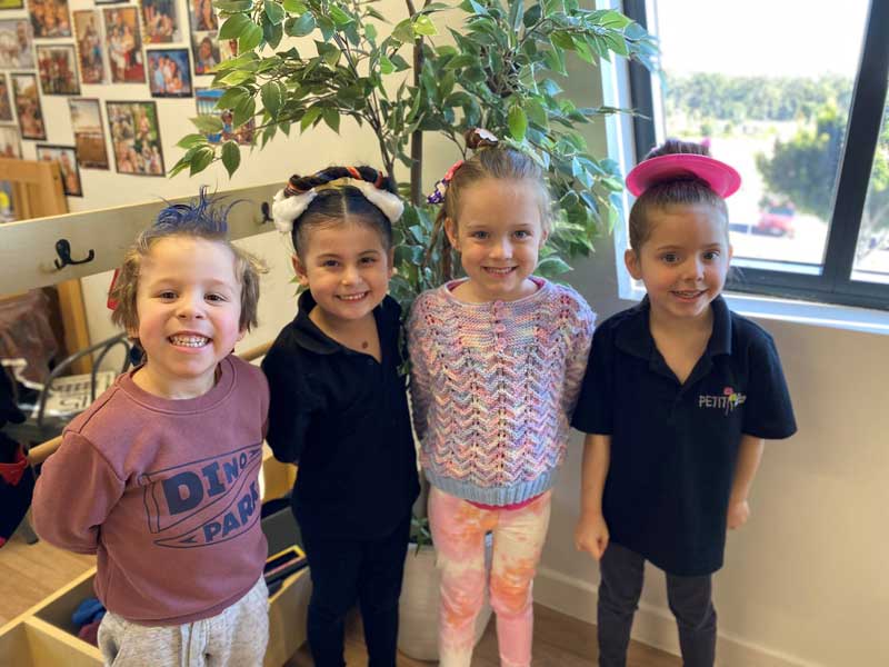 Children with their hair up for crazy hair day preventing head lice from spreading.