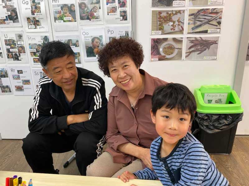 A child celebrates celebrates Grandparents Day in Australia with his grandparents.