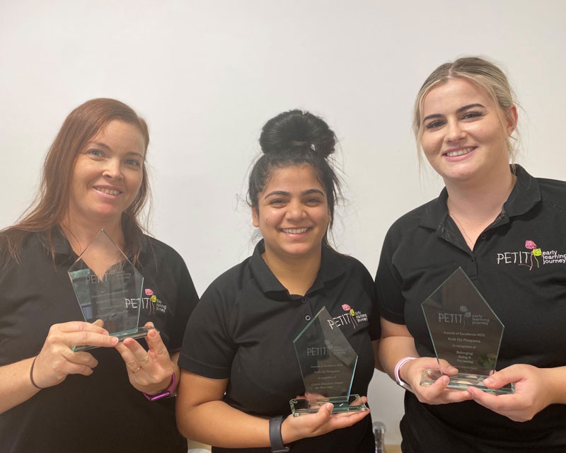 Three Educators from Petit ELJ Pimpama with their Awards of Excellence, celebrating teachers as role models for children