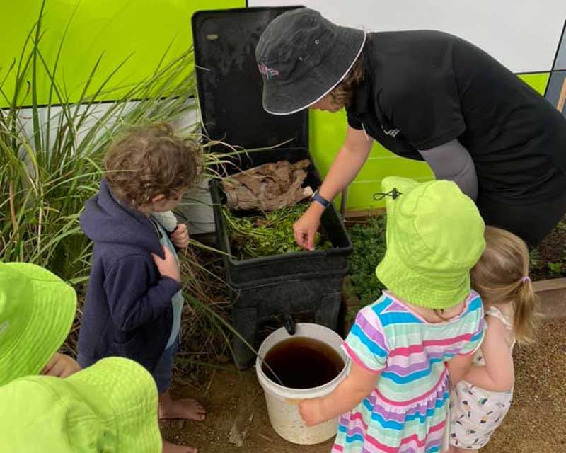 Float Educator with Petit Early Learning Journey showing children how worm juice is made.