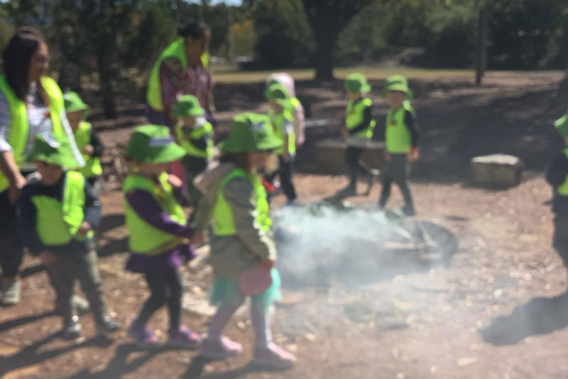 Petit ELJ Barton children participating in a smoking ceremony during an excursion discovering cultural diversity Australia offers.