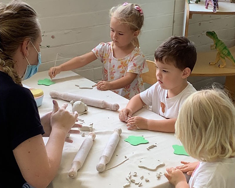 Three children participate in pottery classes with instructor, Jaymi at Petit ELJ Woolwin.