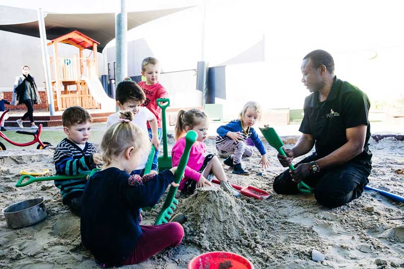 Children engage in cooperative play - one of six stages of child play where shyness in child development may be observed.