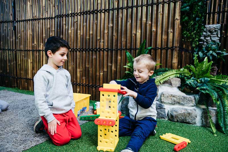 Children sharing toys and playing together.