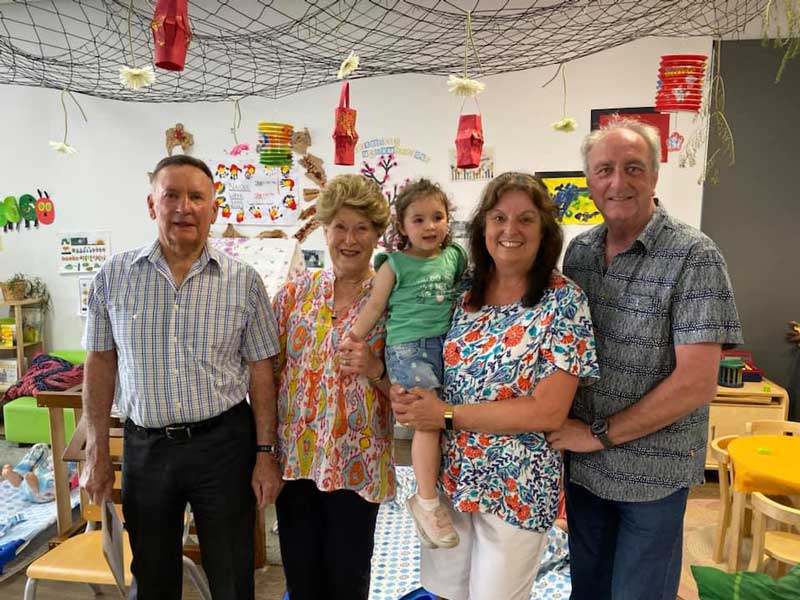 Two pairs of grandparents and their grandchild at a Petit ELJ Grandparents Day celebration.