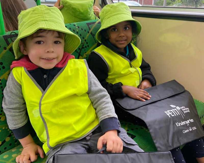  Two kindergarten children on the bus for an excursion.