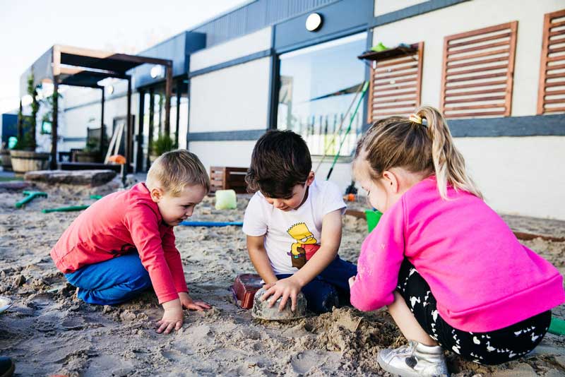 Children playing. When children bump heads they can transfer head lice.