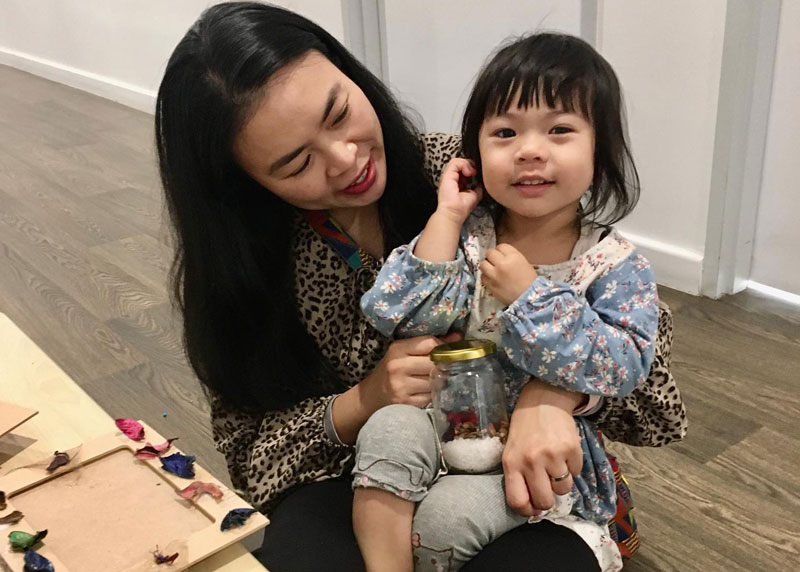 Mum with a child in lap celebrating Mother's Day in Australia.