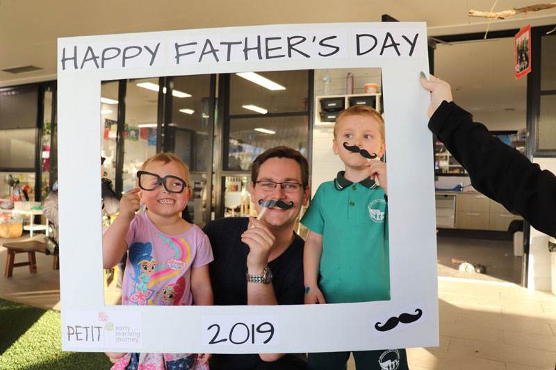 Children and their dad celebrate Father's Day at Petit Early Learning Journey with a photo shoot.