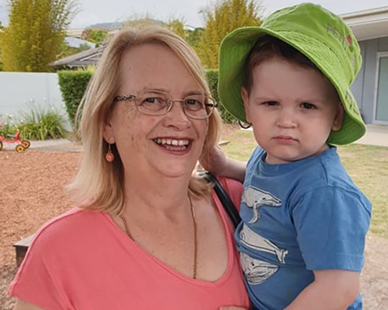 A grandmother holds her grandchild while participating in their early childhood learning showing why grandparents are important.