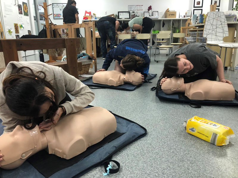 Educators participate in group retraining for CPR certification which is updated in our LMS.