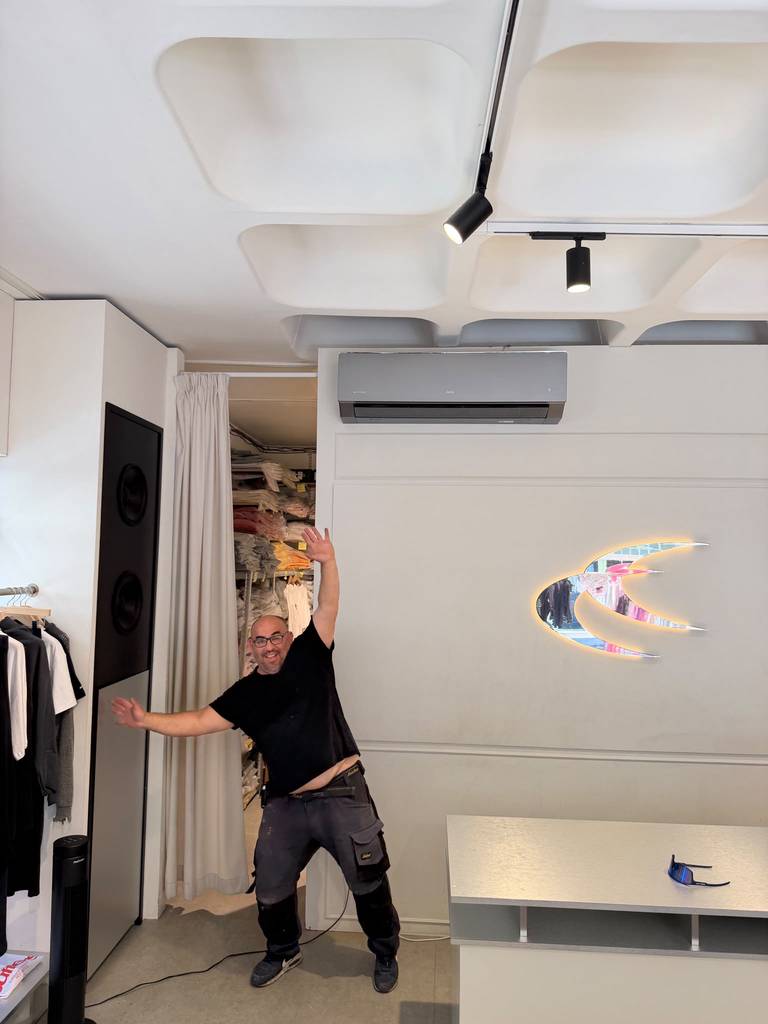 Warm & Cool London engineer celebrating completed installation in boutique